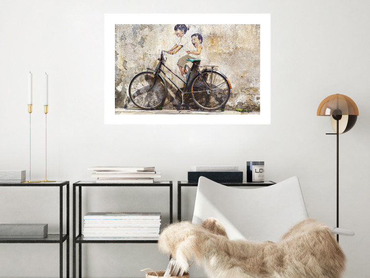 Poster Carefree - retro black bicycle against a wall painted with children 130457 additionalImage 8