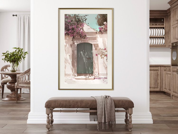 Wall Poster Charming Alley - architecture of a wall with a green entrance in the sunlight 135757 additionalImage 22