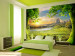 Wall Mural Peaceful Meadow - landscape with trees against mountains and a rising sun 59778