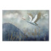 Canvas Art Print A Heron in Flight - A Bird Flying Against the Background of Dark Blue Mountains Covered With Fog 151209