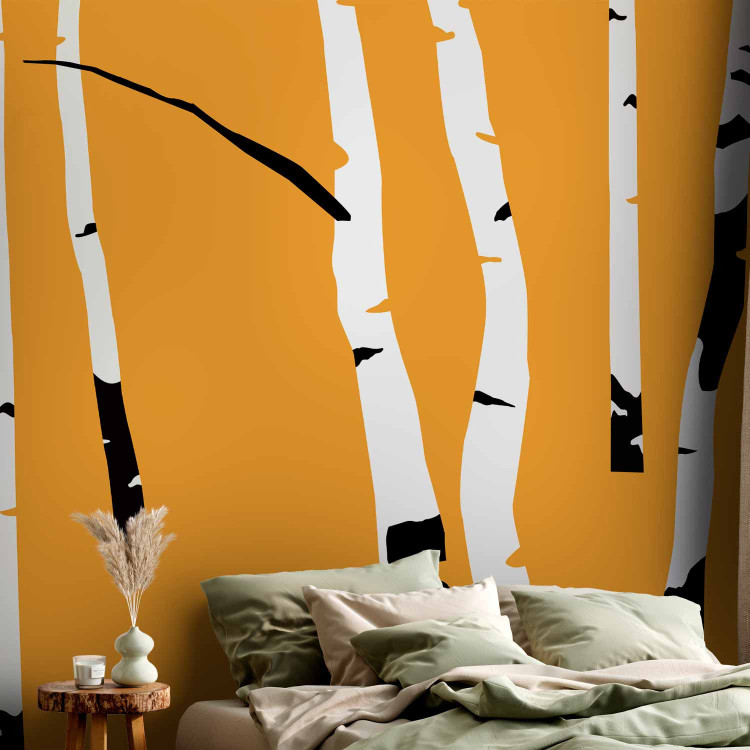 Wall Mural Birch forest - black and white tree trunks on an orange coloured background 96609 additionalImage 2