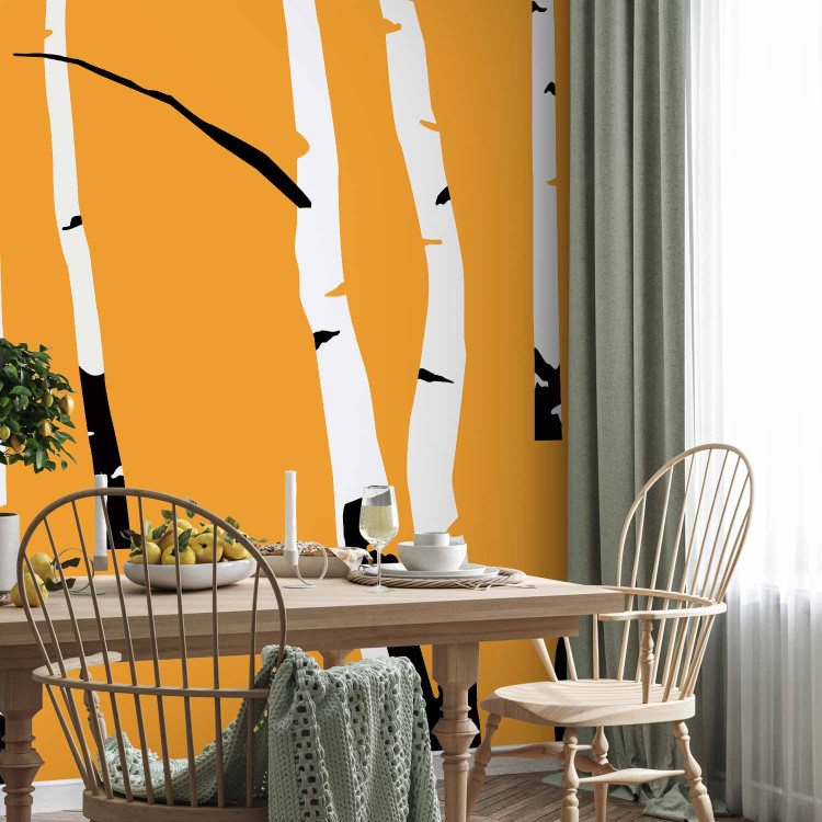Wall Mural Birch forest - black and white tree trunks on an orange coloured background 96609 additionalImage 7