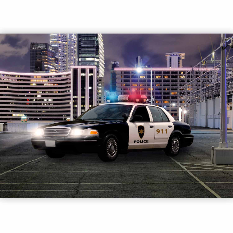 Wall Mural Police car at night - police car motif on a background of city architecture 97049 additionalImage 1