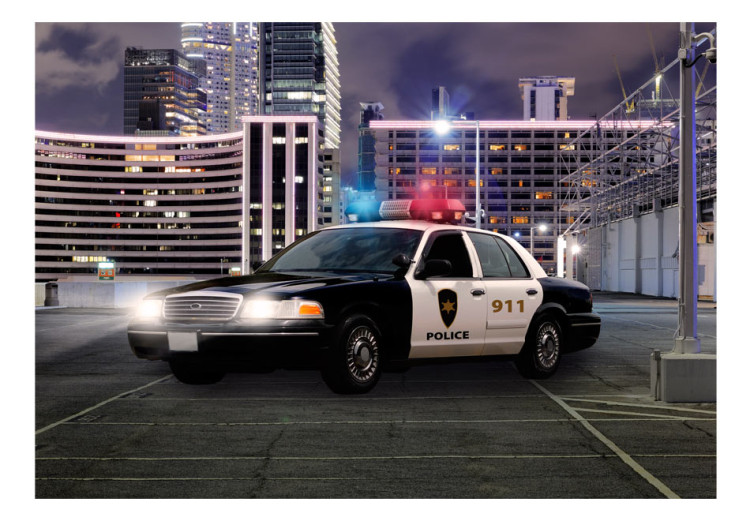 Wall Mural Police car at night - police car motif on a background of city architecture 97049 additionalImage 1
