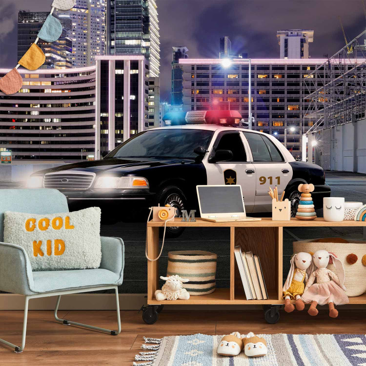 Wall Mural Police car at night - police car motif on a background of city architecture 97049